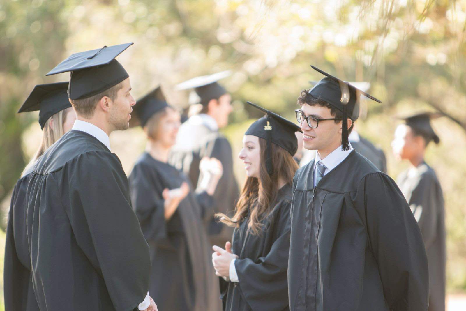 grads in caps and gowns standing around