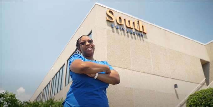Lakisha Fountain, BSN grad, standing in front of South University campus building
