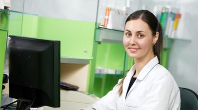 Female healthcare administrator sitting at computer-alt-text