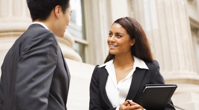 Male and female having a conversation in front of courthouse-alt-text