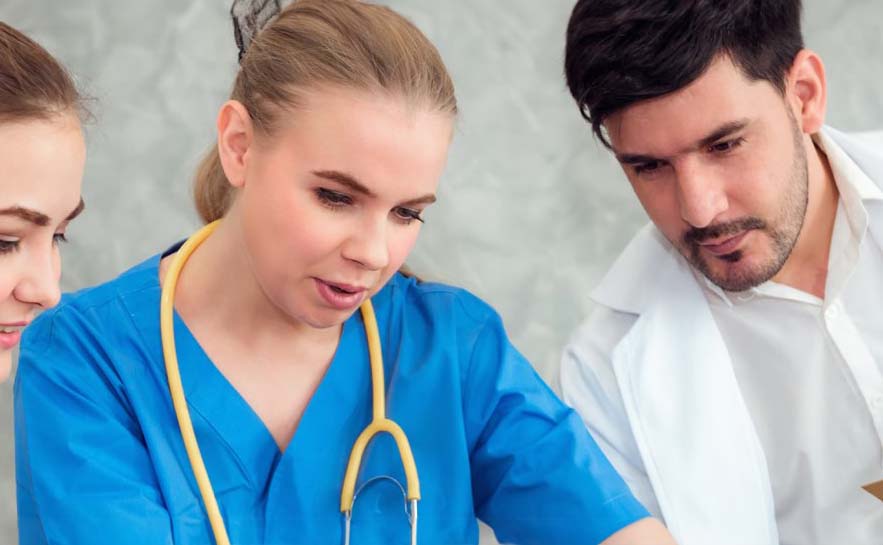 Two individuals, one in scrubs with a stethoscope and one in a white shirt and jacket.