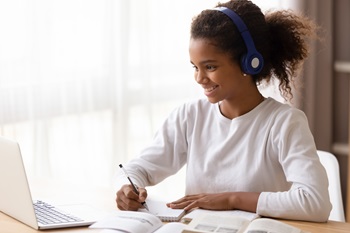 young african american girl researching information on her laptop