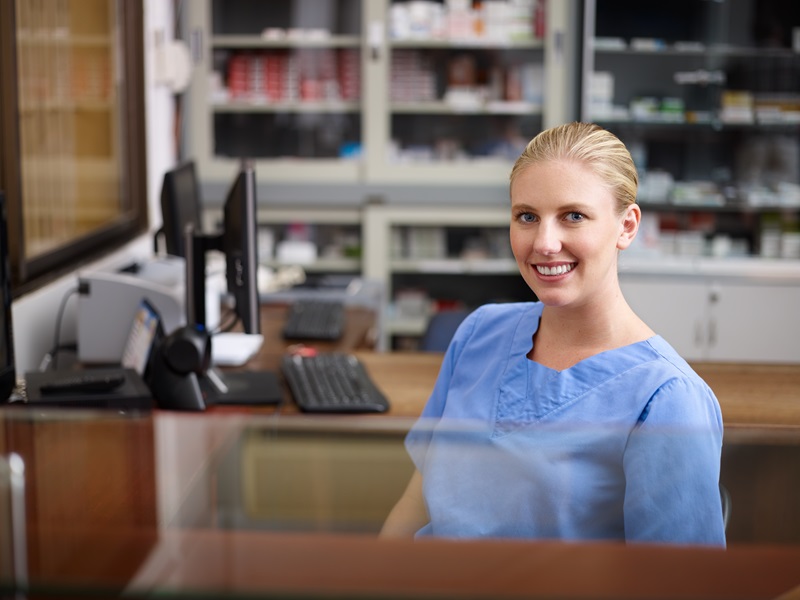 healthcare worker sitting at a work computer station